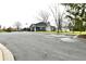 Community clubhouse surrounded by trees and parking area at 9640 Clover Leaf Ln, Fishers, IN 46038