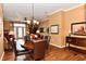 Elegant dining area featuring hardwood floors, decorative lighting, and neutral walls at 9640 Clover Leaf Ln, Fishers, IN 46038