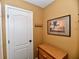 Neutral hallway with wall art and wood accent furniture at 9640 Clover Leaf Ln, Fishers, IN 46038