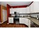 Beautiful kitchen features white cabinetry, stainless steel appliances, and grey backsplash at 9640 Clover Leaf Ln, Fishers, IN 46038