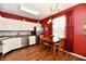 Bright kitchen features white cabinetry, hardwood floors, stainless steel appliances, and dining area at 9640 Clover Leaf Ln, Fishers, IN 46038