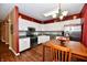 Bright kitchen features stainless steel appliances, white cabinets, grey backsplash, and hardwood floors at 9640 Clover Leaf Ln, Fishers, IN 46038
