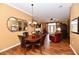 Open living room features dining area, fireplace, hardwood floors, and bright natural light at 9640 Clover Leaf Ln, Fishers, IN 46038