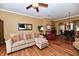 Cozy living room that flows into dining area with hardwood floors and lots of natural lighting at 9640 Clover Leaf Ln, Fishers, IN 46038