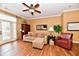Cozy living room with hardwood floors, tan sectional, and lots of natural lighting at 9640 Clover Leaf Ln, Fishers, IN 46038