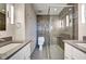 Modern bathroom with sleek glass-enclosed shower, dual sinks, and contemporary fixtures at 110 E Washington St # 1102, Indianapolis, IN 46204