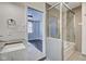 Modern bathroom boasts glass-enclosed shower, and stone countertop vanity at 110 E Washington St # 1102, Indianapolis, IN 46204