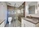 Modern bathroom featuring glass shower, modern lighting, vanity with white cabinets, and gray countertop at 110 E Washington St # 1102, Indianapolis, IN 46204