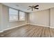 Bedroom features modern ceiling fan, city views, and wood floors at 110 E Washington St # 1102, Indianapolis, IN 46204