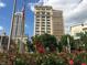 Exterior street view with flowers in foreground and skyline in the background at 110 E Washington St # 1102, Indianapolis, IN 46204