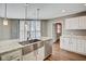 Kitchen featuring stainless steel farmhouse sink, granite countertops, and ample cabinet space at 110 E Washington St # 1102, Indianapolis, IN 46204