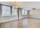 Inviting living room with wood floors, a ceiling fan, large windows, and natural light at 110 E Washington St # 1102, Indianapolis, IN 46204