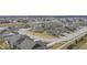 Expansive aerial view of a neighborhood featuring stylish homes, ponds, and manicured common areas at 11758 Harvester S Cir, Noblesville, IN 46060
