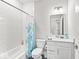 Bright bathroom featuring a tub with white tile and a vanity with white cabinets and marble countertop at 11758 Harvester S Cir, Noblesville, IN 46060