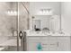 Elegant bathroom with a glass enclosed tile shower, double sink vanity, and bright lighting at 11758 Harvester S Cir, Noblesville, IN 46060