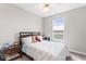 Cozy bedroom with a queen-sized bed, a nightstand, and a window showcasing a view of the outdoors at 11758 Harvester S Cir, Noblesville, IN 46060