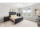 Large bedroom with a dark wood bed frame, neutral walls, carpet, and natural light from the windows at 11758 Harvester S Cir, Noblesville, IN 46060