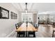 Dining room showcasing a large wooden table, modern lighting, and views into living space at 11758 Harvester S Cir, Noblesville, IN 46060