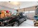 Spacious two car garage with storage and a black SUV parked inside at 11758 Harvester S Cir, Noblesville, IN 46060
