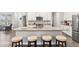Spacious kitchen island features a sink, seating, and modern finishes at 11758 Harvester S Cir, Noblesville, IN 46060