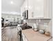 Open concept kitchen showcasing stainless steel appliances and an open view to the living room at 11758 Harvester S Cir, Noblesville, IN 46060