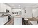 Modern kitchen boasts white cabinets, stainless steel appliances, and a large island with seating at 11758 Harvester S Cir, Noblesville, IN 46060