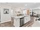 Open-concept kitchen with a large island connecting to the dining and living spaces at 11758 Harvester S Cir, Noblesville, IN 46060