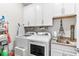 Well-lit laundry room with modern appliances, ample storage, and a convenient sink area at 11758 Harvester S Cir, Noblesville, IN 46060