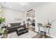 Comfortable living room with a gray sofa, contemporary decor, and an open view to the kitchen at 11758 Harvester S Cir, Noblesville, IN 46060