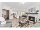 Bright, open-concept living area with a modern fireplace and dining space at 11758 Harvester S Cir, Noblesville, IN 46060