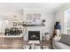 Open-concept living room with fireplace and view of the dining area at 11758 Harvester S Cir, Noblesville, IN 46060