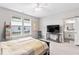 Bright main bedroom with views from the windows and a doorway to the bathroom and walk-in closet at 11758 Harvester S Cir, Noblesville, IN 46060