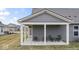 Enjoy outdoor living on this covered patio with ample seating space, perfect for relaxing or entertaining at 11758 Harvester S Cir, Noblesville, IN 46060