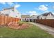 Inviting backyard featuring a brick firepit, lawn, and a view of neighboring homes at 1210 S State Ave, Indianapolis, IN 46203