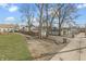Large backyard with mature trees and a gravel alley at 1210 S State Ave, Indianapolis, IN 46203