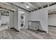 Finished basement with stacked washer and dryer units and rolling metal storage at 1210 S State Ave, Indianapolis, IN 46203