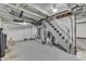 Unfinished basement space with stairs and exposed ductwork offers potential for customization and additional living area at 1210 S State Ave, Indianapolis, IN 46203