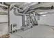 Unfinished basement features a furnace and concrete flooring, offering potential for storage or future renovation at 1210 S State Ave, Indianapolis, IN 46203