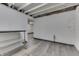 Finished basement area with sleek wood-look flooring and storage shelves offers a versatile space at 1210 S State Ave, Indianapolis, IN 46203