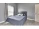 Cozy bedroom featuring a comfortable bed, stylish curtains, and natural light from the window at 1210 S State Ave, Indianapolis, IN 46203