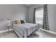 Comfortable bedroom with gray walls and natural light from the window, creating a calming space at 1210 S State Ave, Indianapolis, IN 46203