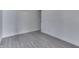 Empty room with a minimalist design featuring sleek, wood-look floors and bright white walls at 1210 S State Ave, Indianapolis, IN 46203