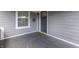 Inviting covered porch with a welcoming doormat and painted siding, offering a comfortable outdoor space at 1210 S State Ave, Indianapolis, IN 46203