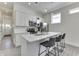 Modern kitchen featuring white cabinets, stainless steel appliances, and a quartz-topped island with bar seating at 1210 S State Ave, Indianapolis, IN 46203