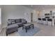 Open-concept interior featuring wood-look flooring, a comfortable sofa, and a stylish coffee table at 1210 S State Ave, Indianapolis, IN 46203