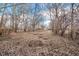The yard has bare trees, a metal fence, and fallen leaves at 1254 Mcdougal St, Indianapolis, IN 46203