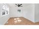 Spacious bedroom featuring light wood floors, a ceiling fan, and natural light from the windows at 1254 Mcdougal St, Indianapolis, IN 46203