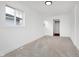Bright bedroom with neutral carpet, white walls, and a view from the window at 1254 Mcdougal St, Indianapolis, IN 46203