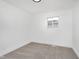 A simple room with carpet, baseboard heat and a window view at 1254 Mcdougal St, Indianapolis, IN 46203