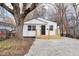 Charming renovated single-story home featuring a new wooden porch and a freshly graveled front yard at 1254 Mcdougal St, Indianapolis, IN 46203